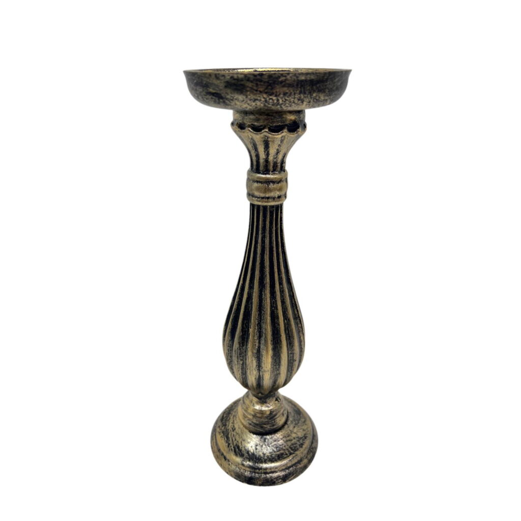 Close-up of an antique brass candlestick with a wide bowl and fluted stem against a white background.